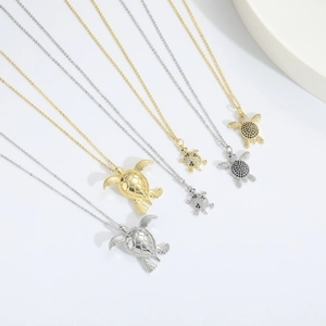 Polished gold and silver turtle pendant necklaces with cubic zirconia pavé settings