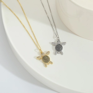 Chic turtle pendant necklace with black and clear cubic zirconia in gold and silver finish
