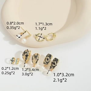 Vintage gold drop earrings set with pearls, turquoise stones, and black enamel designs
