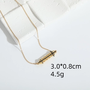 Golden hollow cylinder pendant necklace with black stones on a white stone background