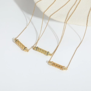 Minimalist gold hollow cylinder pendant necklace set with filigree design and crystals