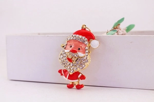Close-up of sparkling Santa Claus charm with red enamel and inlaid crystals