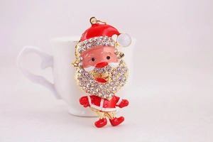 Detail of red enamel Santa Claus keychain with sparkling rhinestones and gold plating