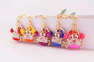 Row of cute crab keychains with sparkling white rhinestones and gold coin charms