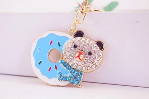 Macro shot of bear keychain with rhinestones and light blue enamel donut detail