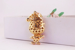 Detail of gold metal Santa keychain featuring an elegant heart-shaped hollow-out back design