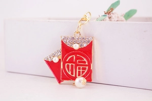 Detail view of the red and gold Chinese Fu fortune charm with rhinestones and pearls