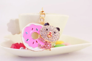 Detail of cute bear and donut keychain with sparkling pink and white rhinestones