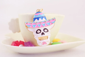 Detail of Day of the Dead skull keychain with rhinestones and pink floral pattern