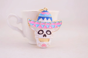 Detailed close-up of a Day of the Dead skull keychain with rhinestones and enamel finish