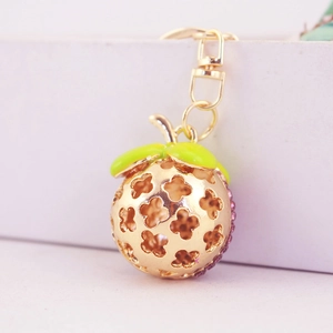 Porte-clés mangoustan tropical avec strass violets et finition en métal doré