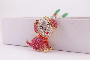 Close-up of cute dog accessory featuring pink rhinestones and golden metal base