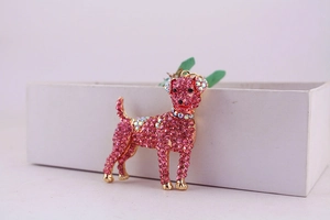 Close-up of pink rhinestone encrusted dog keychain accessory with golden alloy base
