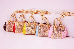Detailed close-up of sparkling rhinestone handbag keychains in various colors with gold hardware