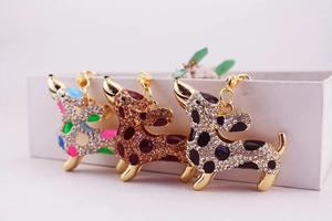 Detailed view of rhinestone puppy keychains with colorful enamel spots on gold finish
