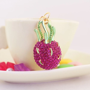 Sparkling pink rhinestone pineapple keychain with green enamel detail and gold ring