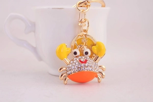 Close-up of cute crab keychain with sparkling rhinestones and golden charm accessory