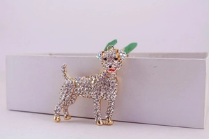 Detail of a sparkling rhinestone dog keychain with crystal embellishments on a gift box