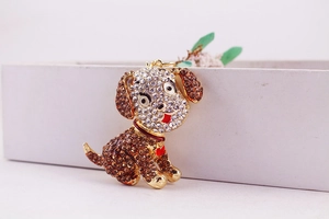 Close-up of cute puppy keychain with gold alloy base and amber crystal rhinestones