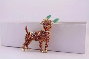 Close-up of golden dog keychain with brown rhinestones and iridescent crystal details