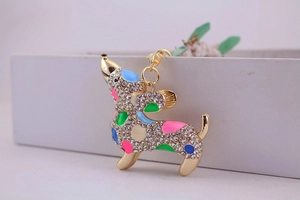 Macro detail of dachshund keychain with golden alloy and colorful rhinestone inlay