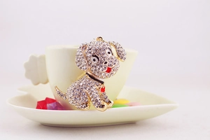 Macro detail of cute puppy keychain with sparkling rhinestones and golden metal base