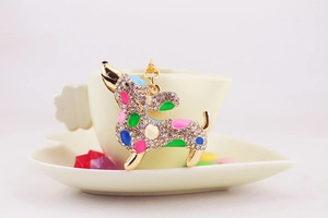 Macro shot of dachshund pendant with colorful enamel and sparkling rhinestones