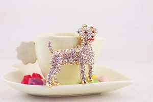Detail showing a sparkling rhinestone puppy keychain with colorful crystals and gold finish