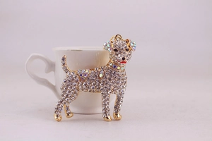 Detailed close-up of a sparkling rhinestone puppy keychain with golden alloy finish