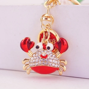 Sparkling crab keychain with red enamel accents and crystal rhinestones in gold plating
