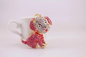 Close-up of cute puppy keychain with sparkling pink and white rhinestones and a red collar