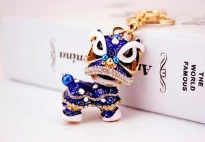 Détail macro du porte-clés lion chinois avec émail bleu et cristaux brillants