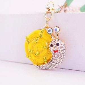 Porte-clés escargot mignon avec coquille en émail jaune et strass brillants en métal doré