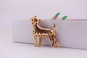 Detailed macro view of golden dog keychain with heart cutouts and blue rhinestones