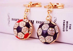 Close-up of sparkling rhinestone soccer keychain with gold lobster clasp and ring