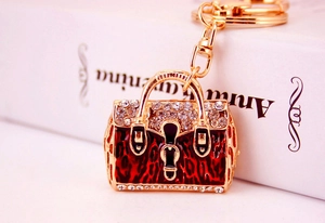 Detail of red leopard enamel handbag keychain with rhinestones and gold plating