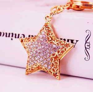 Golden star keychain with sparkling rhinestones and hollow-out design for handbags