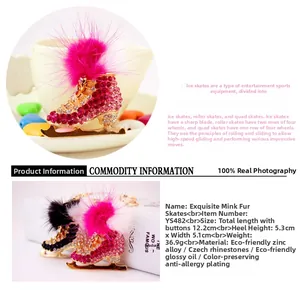 Detail showing fuchsia rhinestone ice skate keychain with soft fur pompom and metal clip