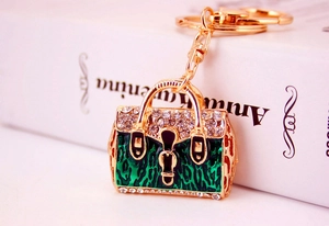 Detailed macro view of the green leopard enamel handbag keychain with sparkling rhinestones