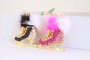 Sparkling crystal ice skate keychains with fluffy fur pom poms and gold metal hardware
