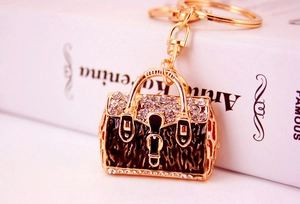 Close-up of leopard print enamel handbag keychain with sparkling rhinestone details