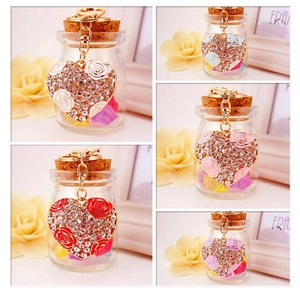 Detail of crystal heart keychains with enamel rose in five colors and gold plating