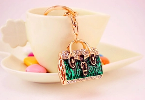 Exquisite gold metal keychain in green leopard handbag shape with sparkling rhinestones