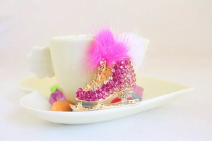 Detailed macro view of pink rhinestone ice skate keychain with fluffy faux fur pom poms