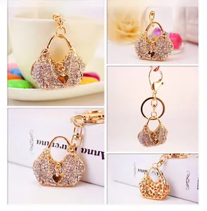 Close-up of rhinestone handbag keychain with heart charm and golden metal finish