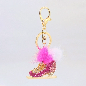 Detail of creative ice skate keychain with gradient pink rhinestones and pom pom charm