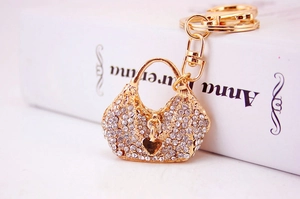 Close-up of heart bag keychain with white rhinestones on golden metal base