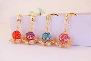 Detailed view of rhinestone pumpkin carriage keychains in various vibrant colors