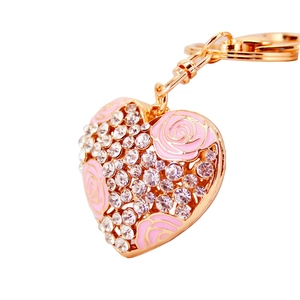 Golden heart-shaped keychain with pink enamel rose and sparkling rhinestones