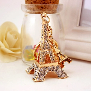 Golden Eiffel Tower keychain with sparkling white rhinestones and a small gold pendant